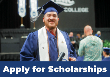 A male DMC graduate in cap and gown