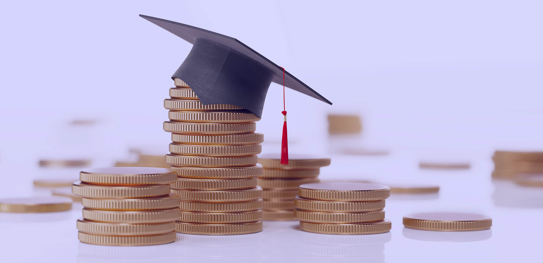 A graduation cap atop a pile of coins