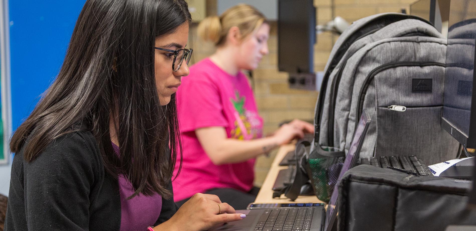 Two female students working at computers