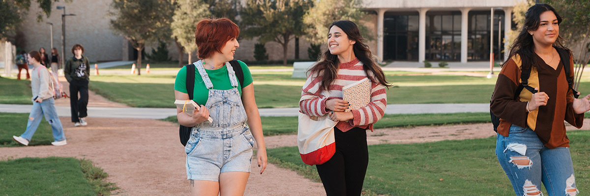 A group of female students walking and smiling