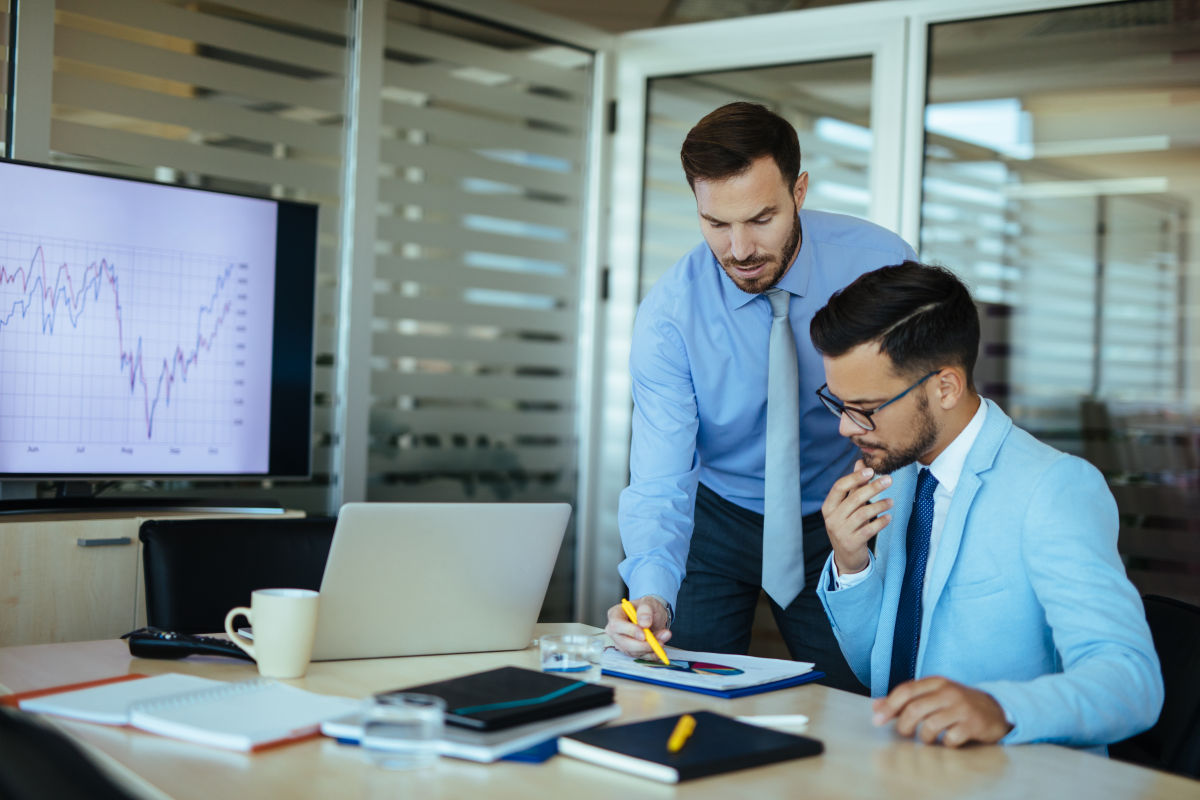 Two male accountants reviewing documents