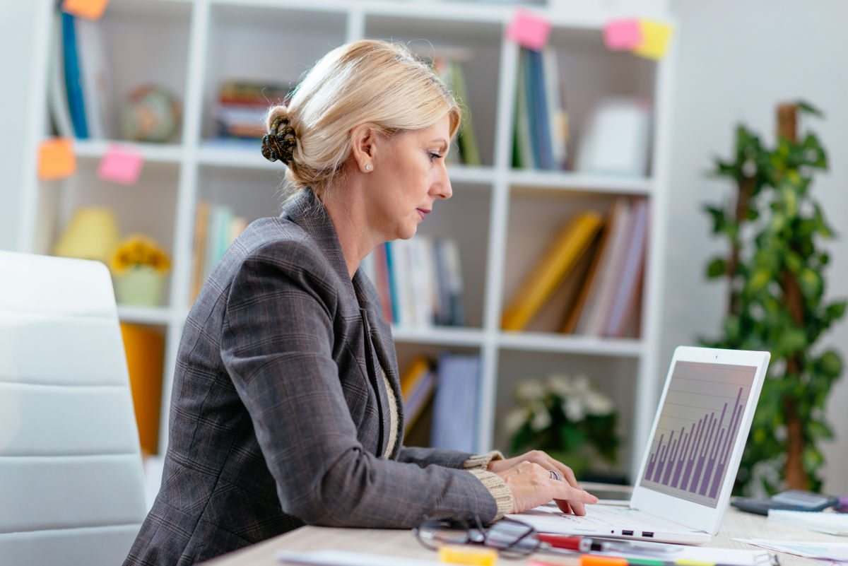 Female accountant at desk with laptop computer