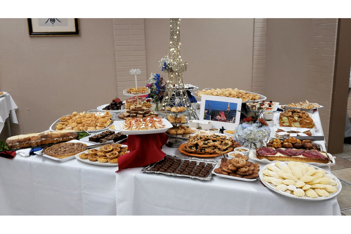 A table displayed with various baked goods