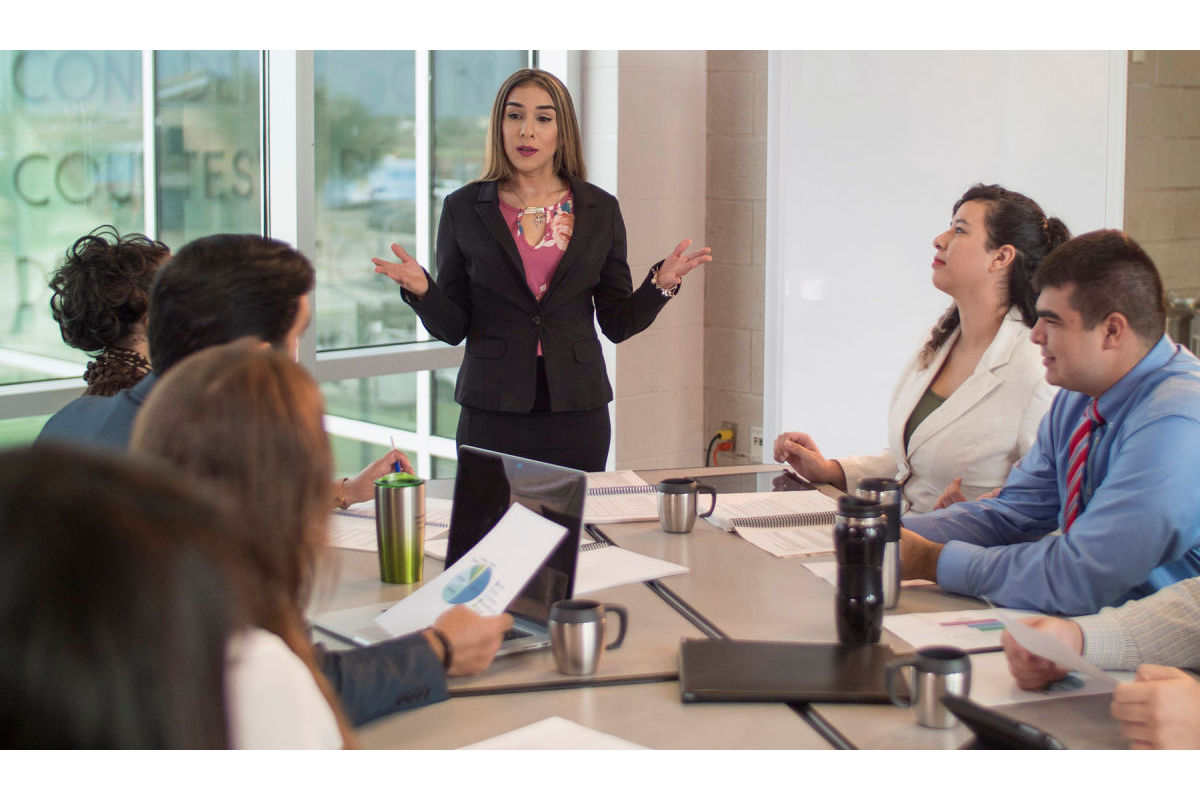 Business woman leads a meeting with co-workers