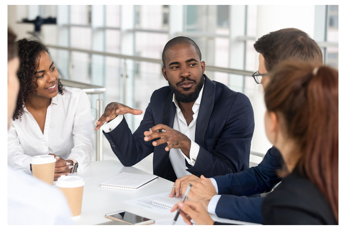 Man discusses business with co-workers