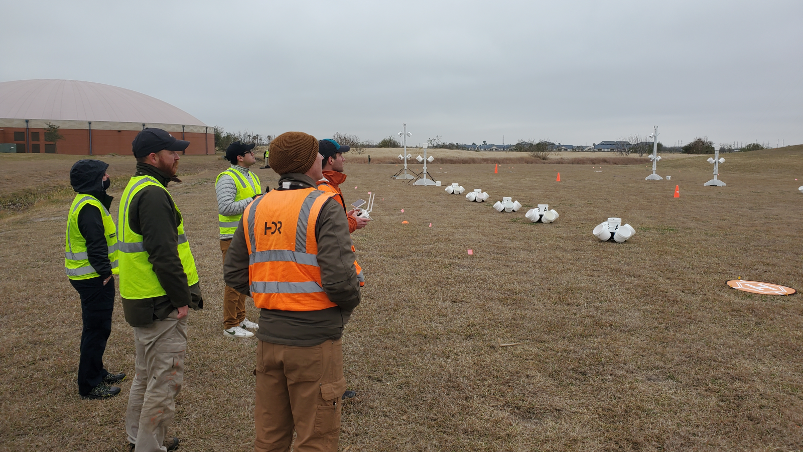 Group of students flying drone through obstacle course.