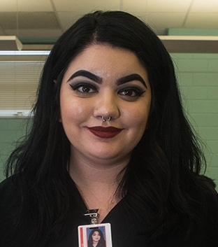 Mia Amos wears a uniform inside a student salon