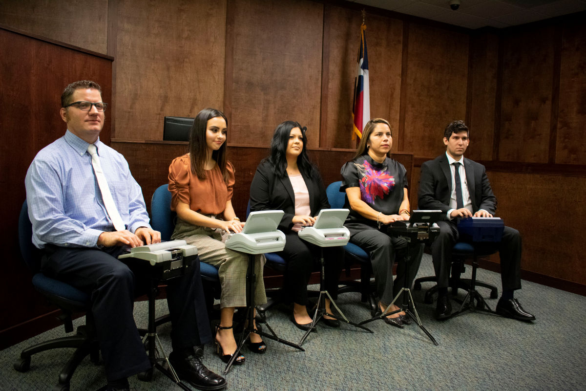 Court reporting students in the courtroom/captioning lab with the steno machines