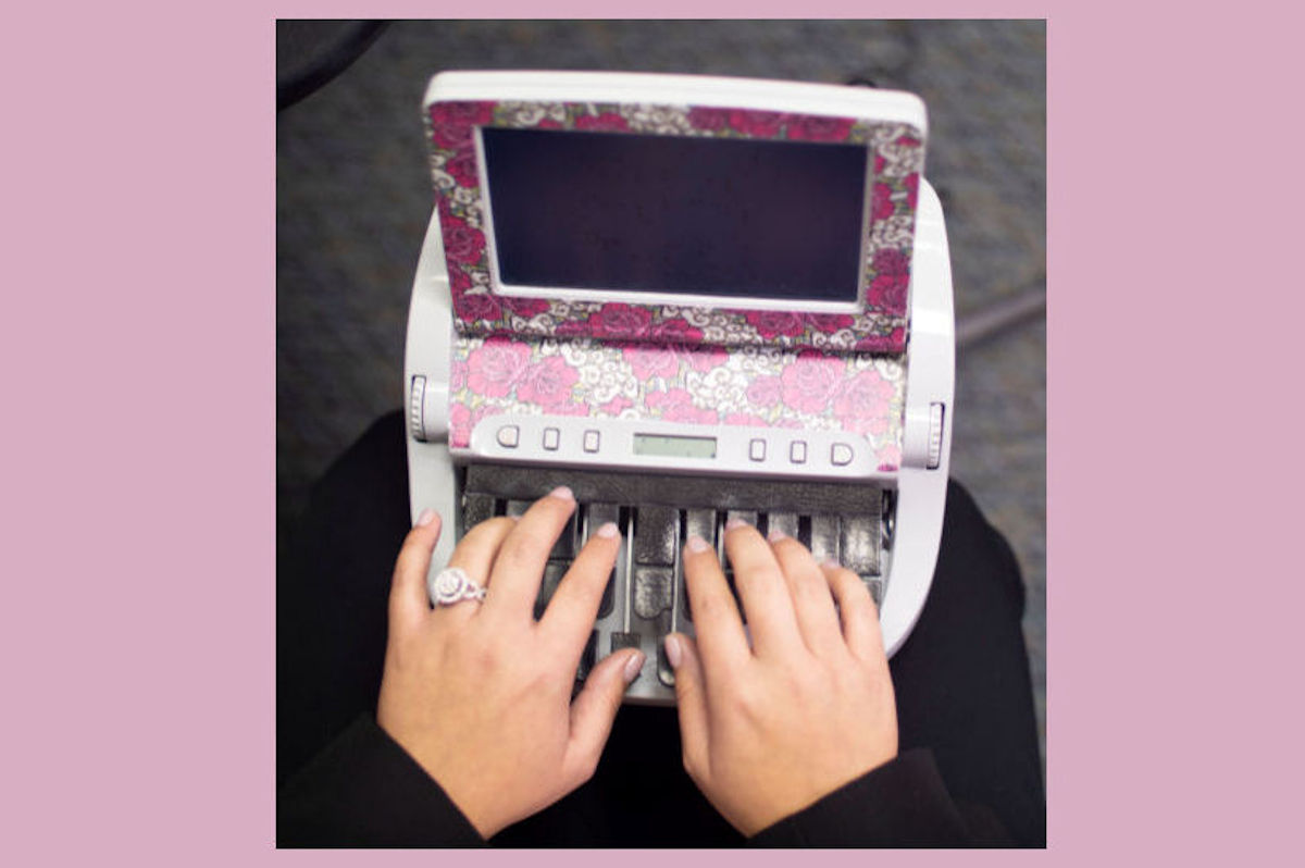 Decorative stenograph machine with a female student's hands typing