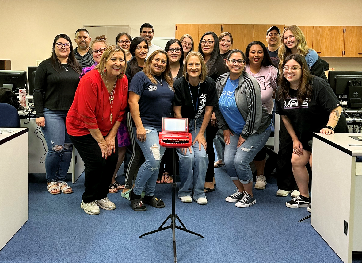 Project Steno students pose for a photo with a transcribing machine