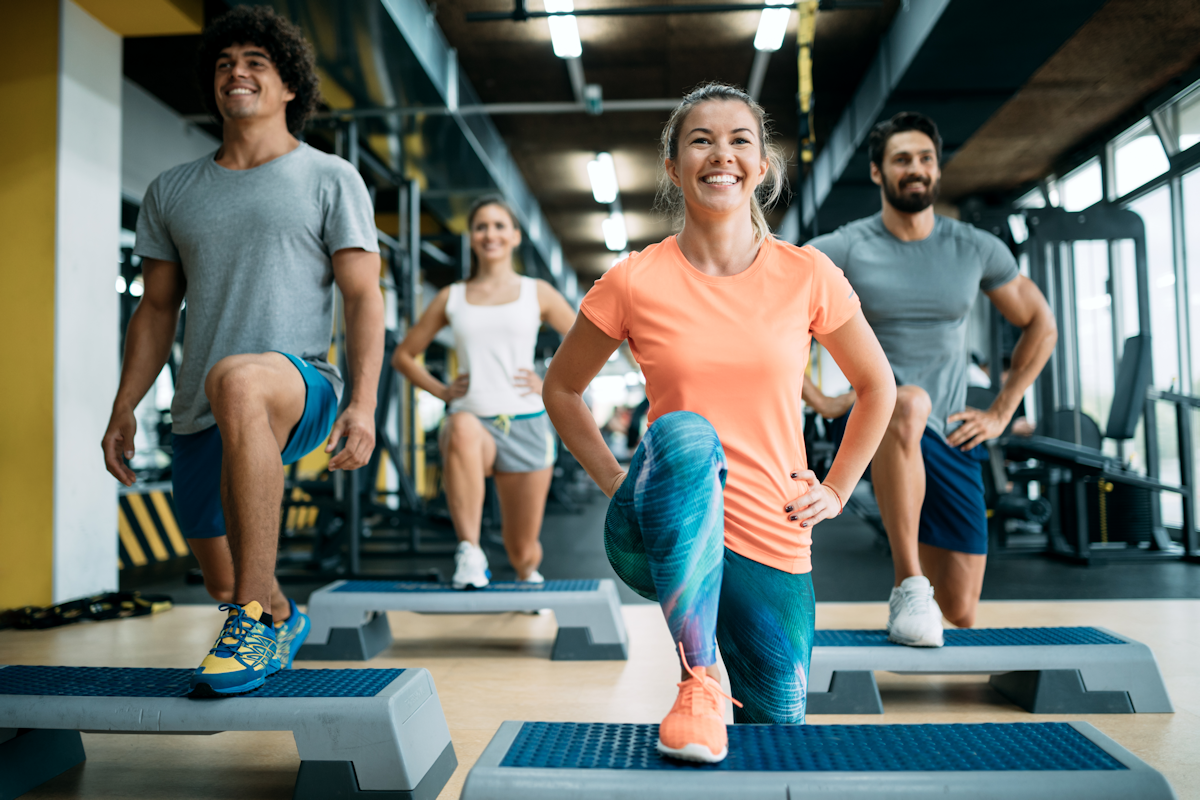 People in the gym in an aerobic step class