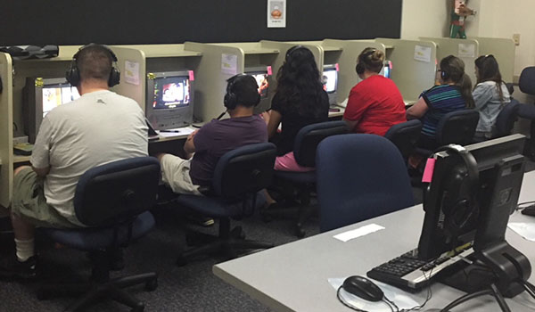 Students work at a row of computers in the Languages Lab.