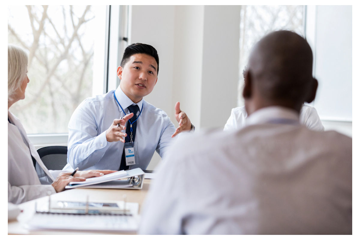 Co-workers speak in a group discussion