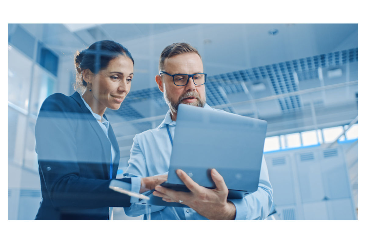 Business woman and man view documents on a laptop