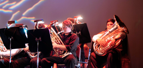 Music students playing instruments in a rehearsal.