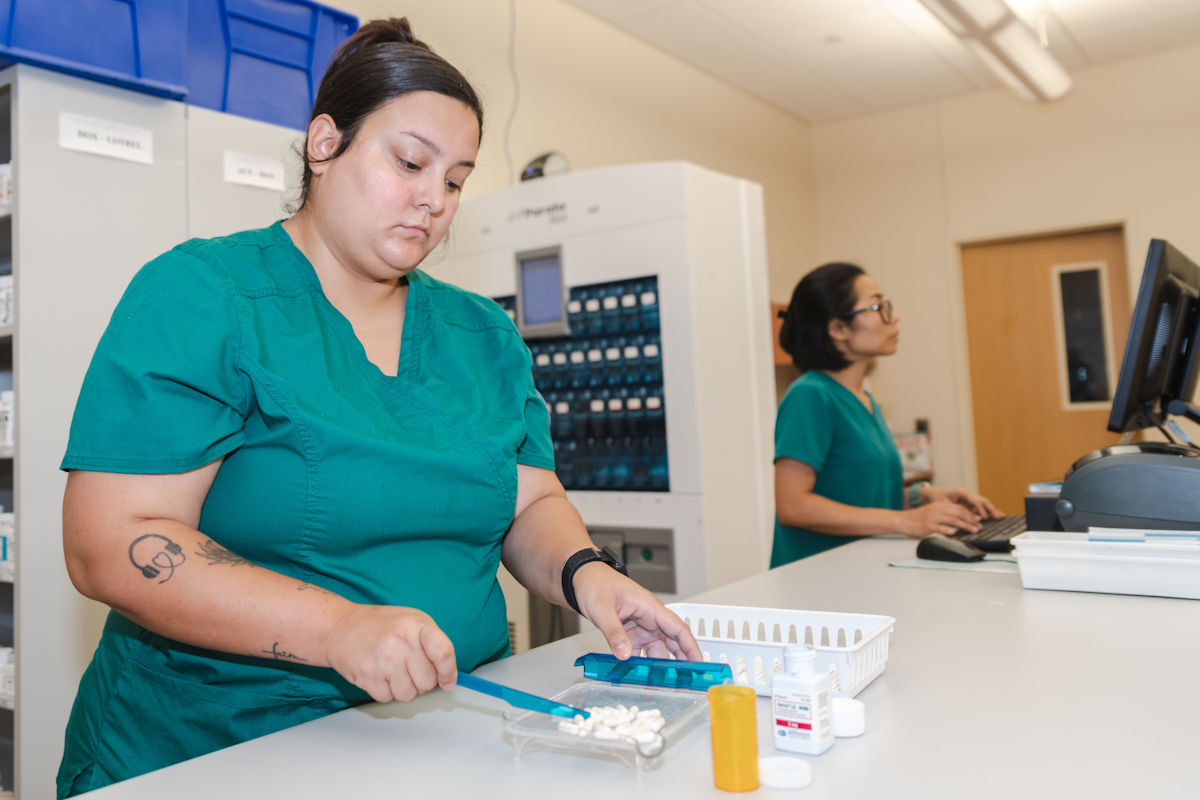 Pharmacy technician filling a prescription order.