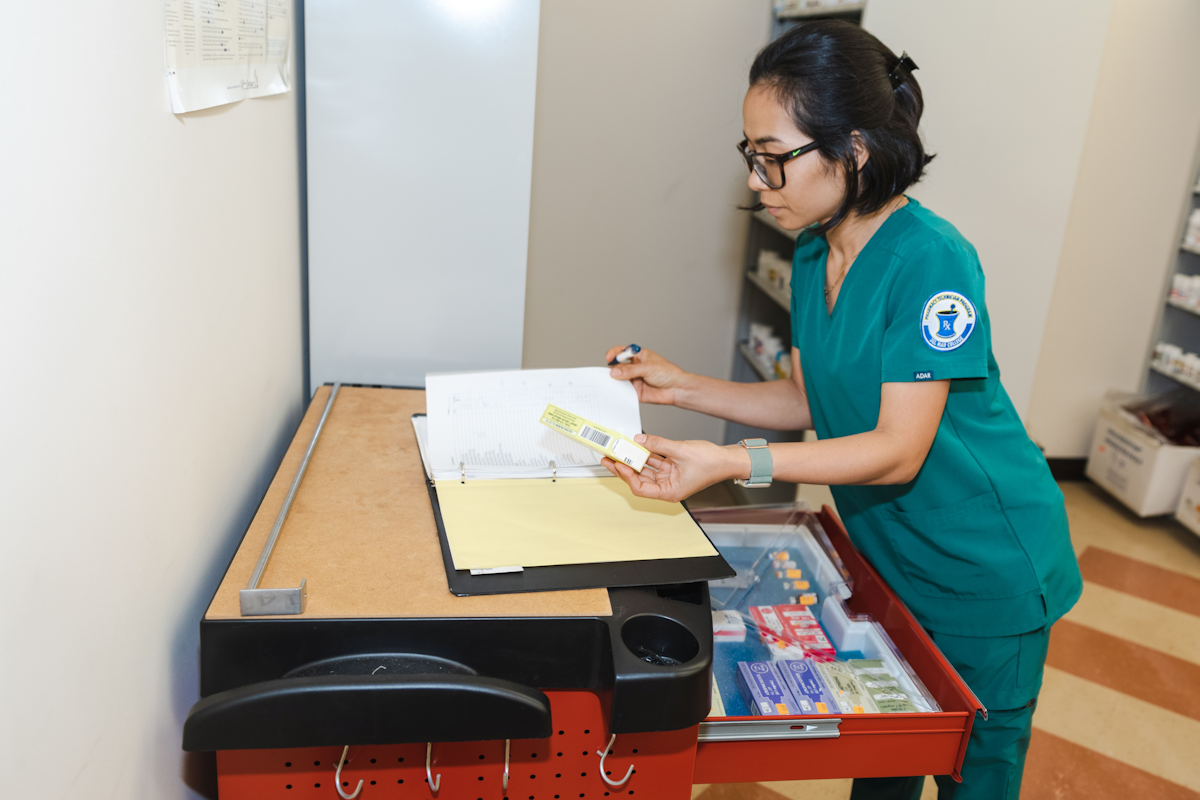 Pharmacy technician taking inventory.