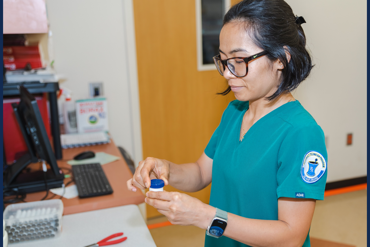 Pharmacy technician preparing ointment.