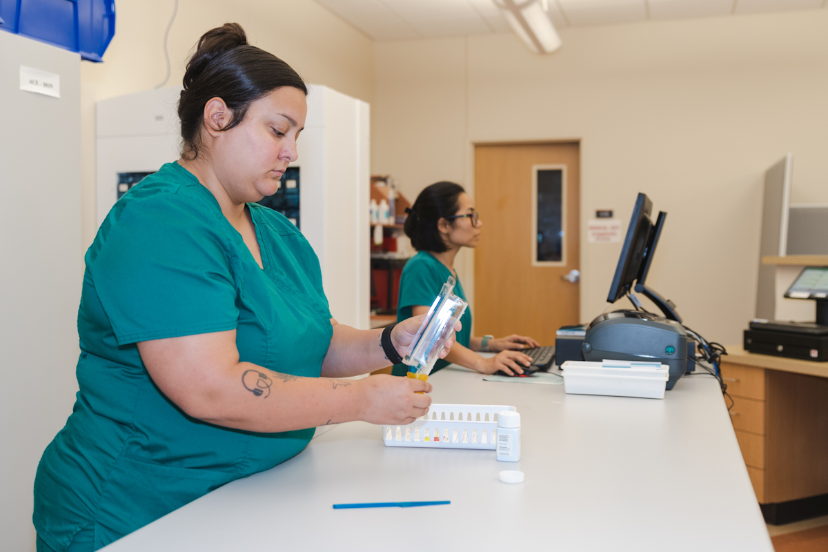 Pharmacy technician taking and filling an order.