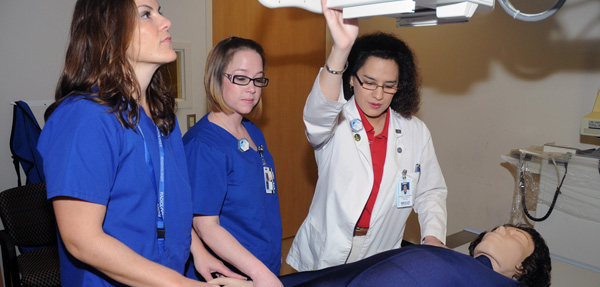 Students work with radiology equipment.