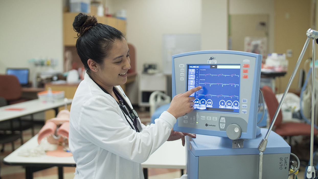 A female student points to information on a monitor