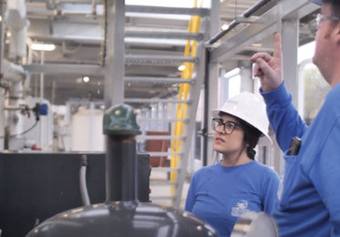 Female Process Technology student being instructed in the training plant