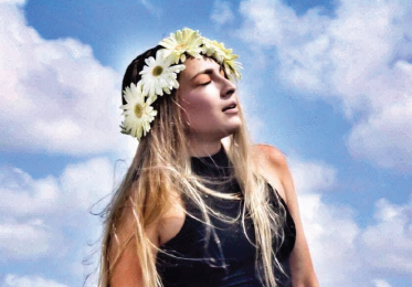 Photo of Catherine George in a field of flowers