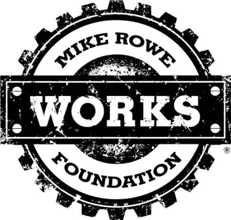 Black and white circular logo featuring a gear design, with "MIKE ROWE" arched at the top, "WORKS" in large bold letters in the center, and "FOUNDATION" below in smaller text.