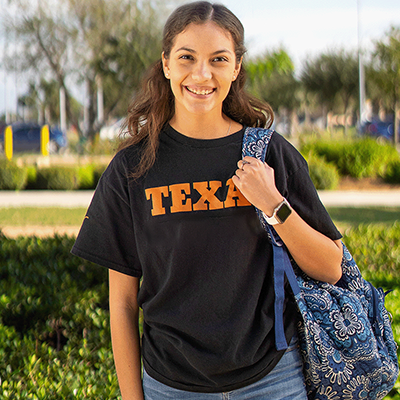 happy female student holding bag with Nursing t-shirt on