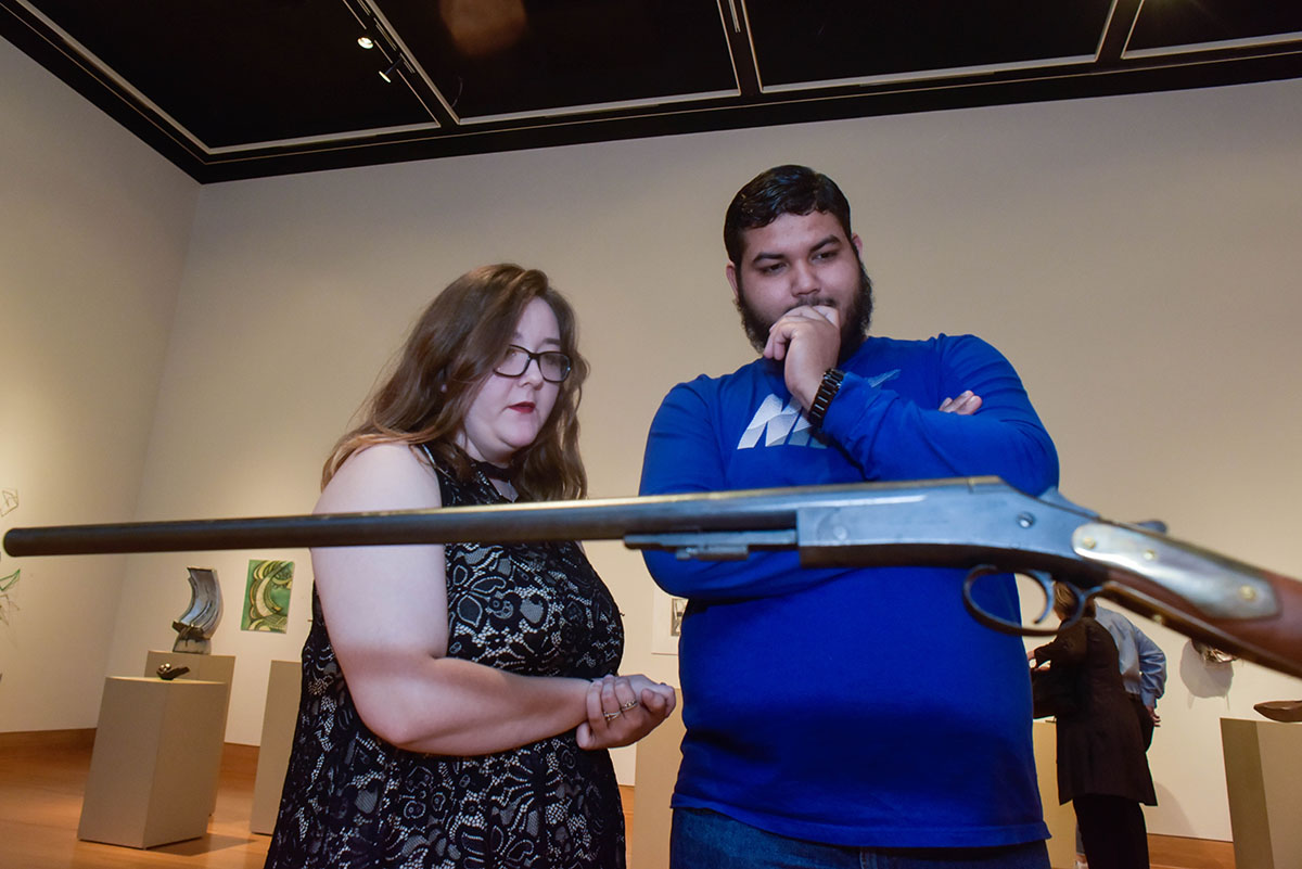 A man and woman view artwork in the Cain Gallery