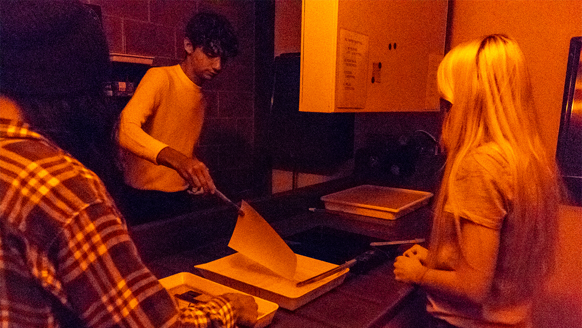 Three students develop photos in a Del Mar's darkroom
