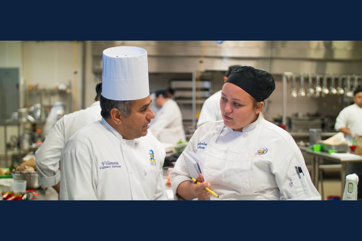 Culinary arts instructor talks with a student