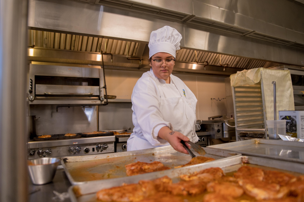 A culinary arts student bakes bread