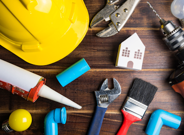A hard hat and various tools on a table