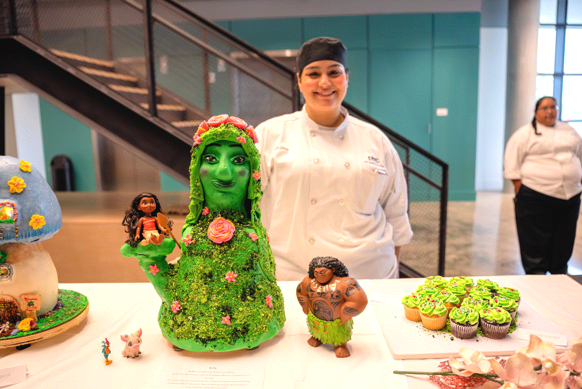 A Del Mar student poses with a cake she made for class