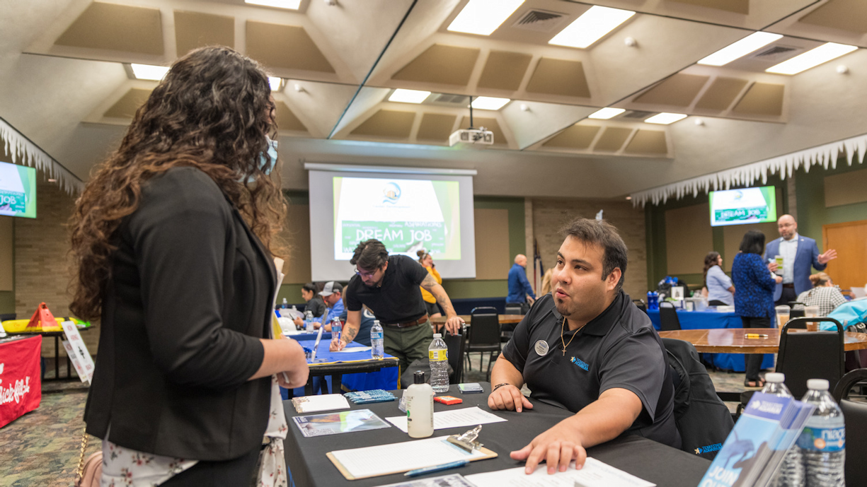 Recruiter discusses job postings with student at career fair