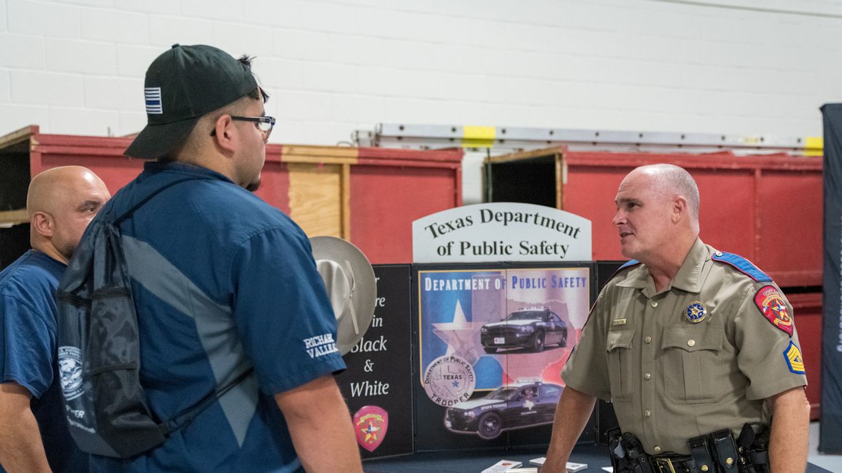 Recruiter discusses job postings with student at career fair