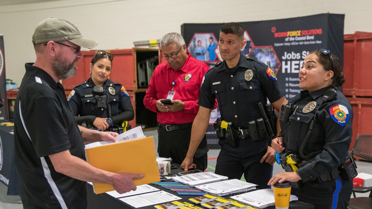 Recruiter discusses job postings with student at career fair