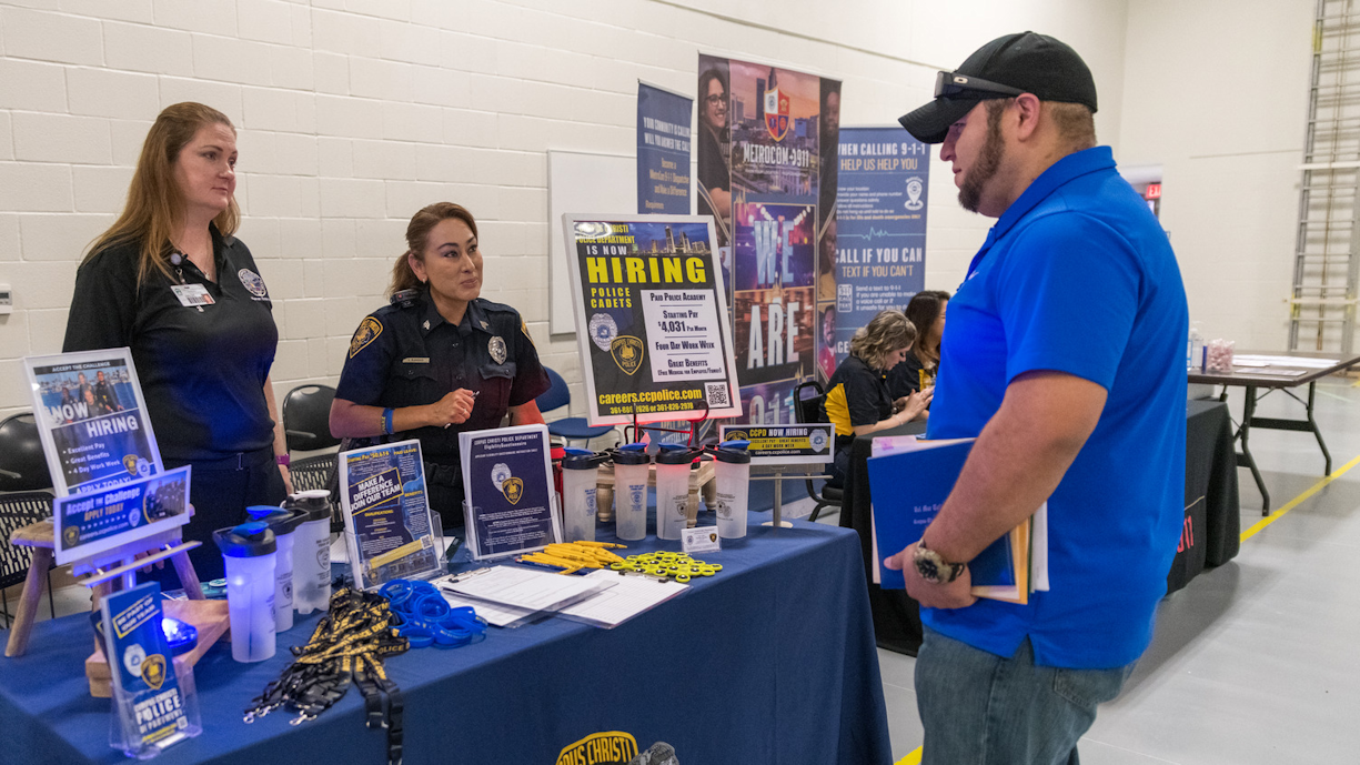 Recruiter discusses job postings with student at career fair