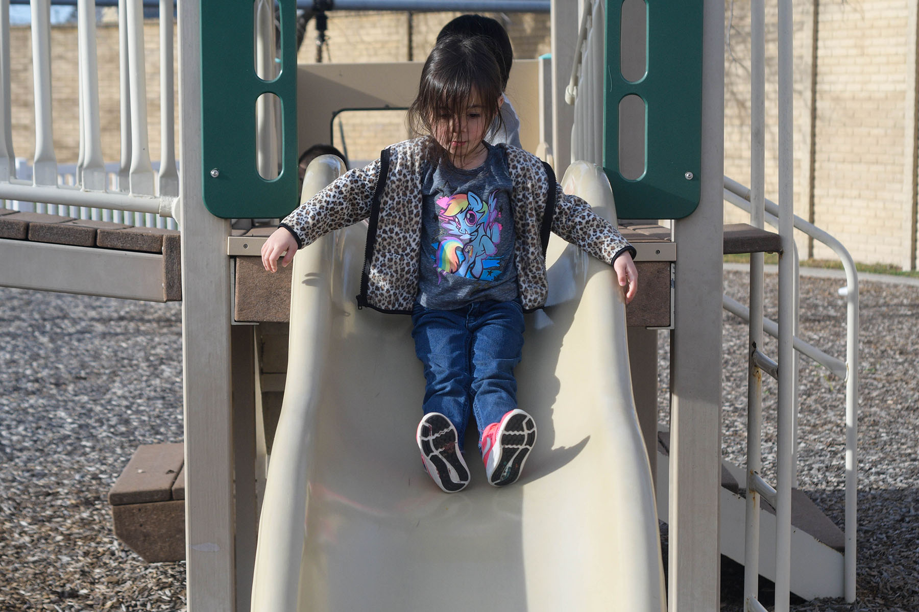 A young girl plays on a slide outside the Center for Early Learning.