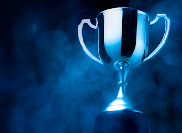 A blue background with a trophy cup in the right center