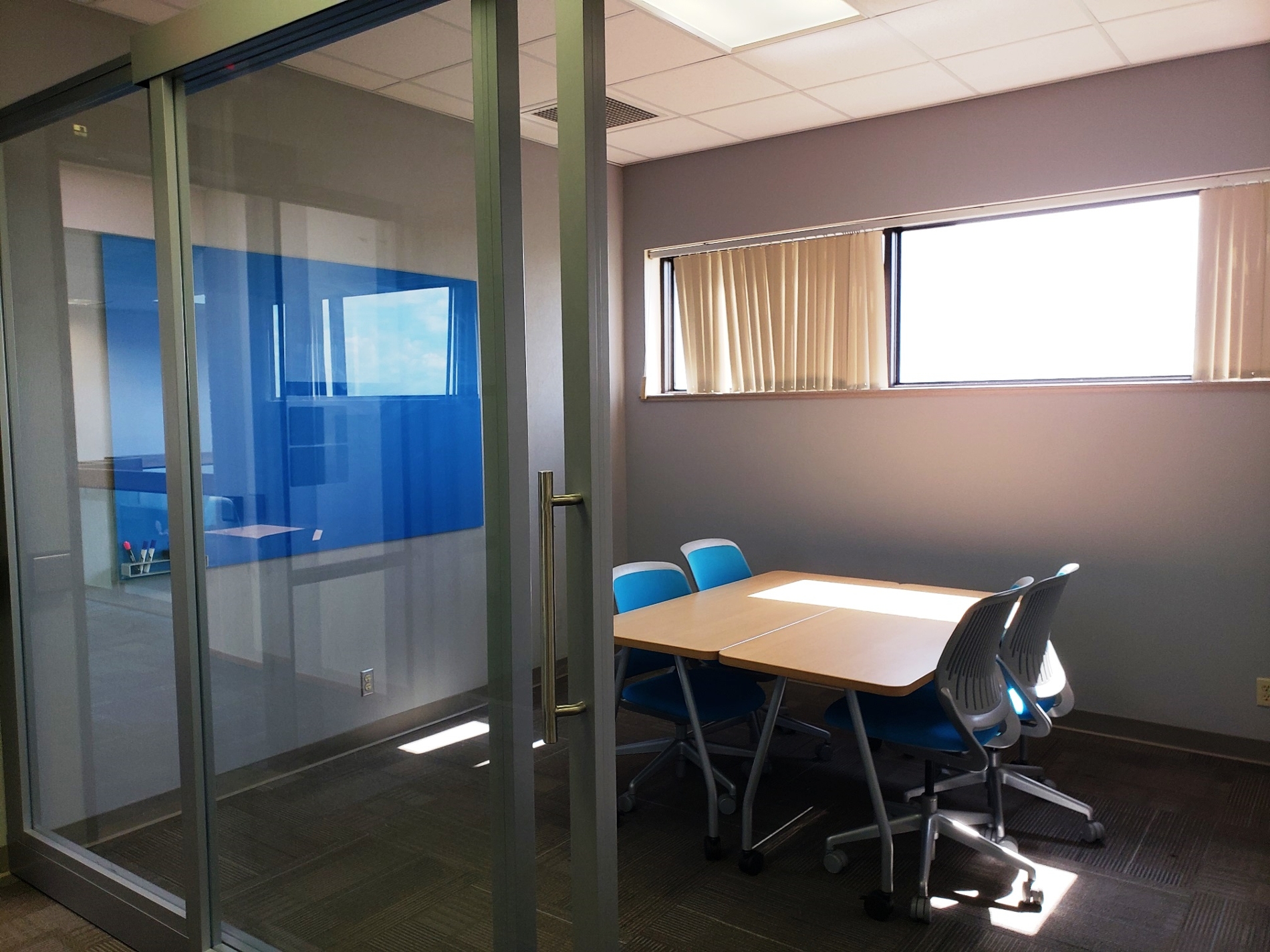 Group study room with table/chairs and a dry erase board.