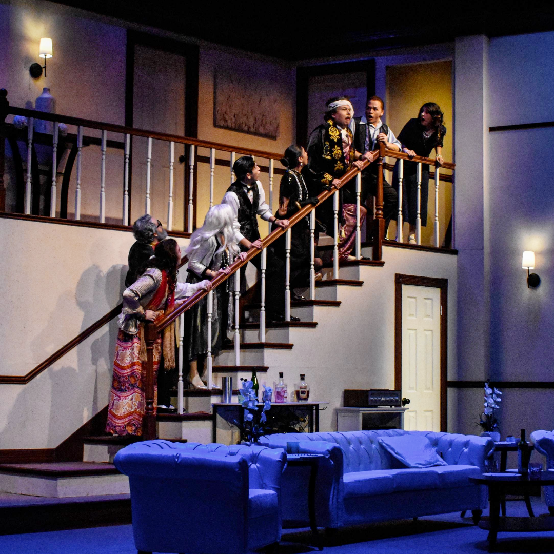 several actors on a staircase onstage