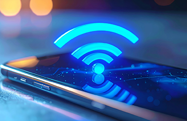Smartphone with a glowing blue Wi-Fi symbol above the screen on a blurred background.