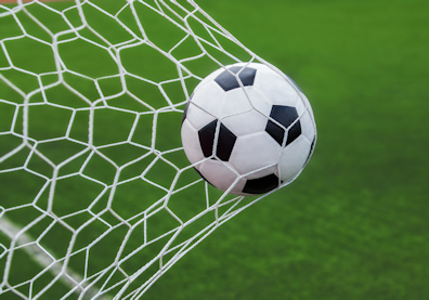 Soccer ball going through a net