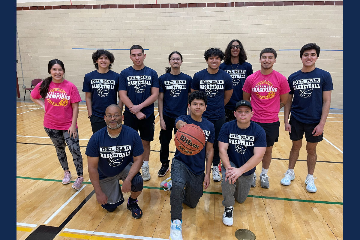 Group of student basketball players posing for a photo