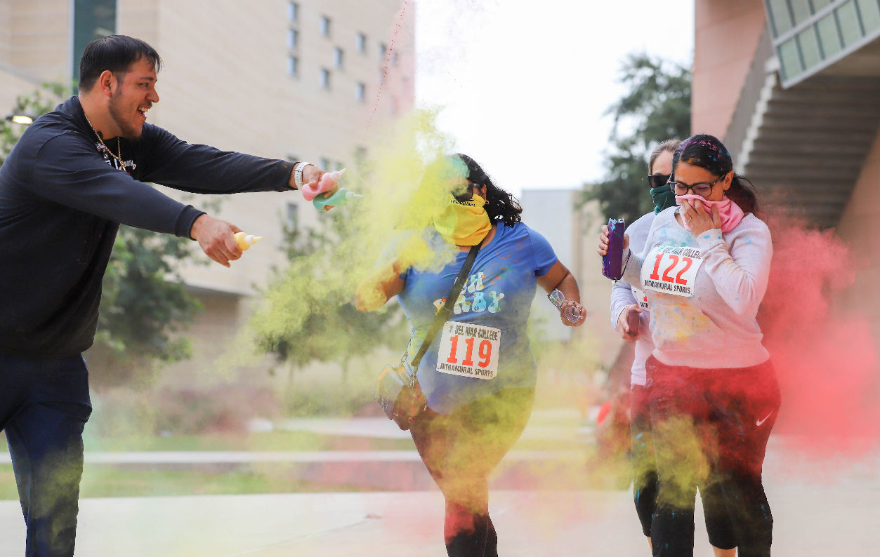 Color run participants have color powder sprinkled on them during the run