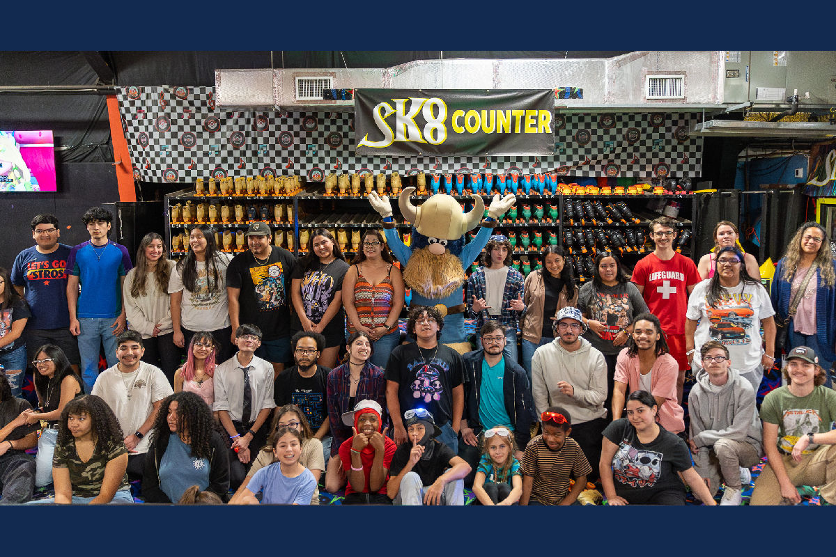 All attendees at skating party pose for photo with Valdar the Viking