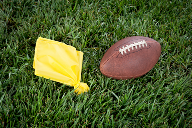 Football and flag on grass field