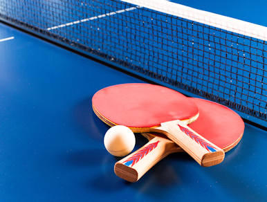 Ping pong paddles on a ping pong table